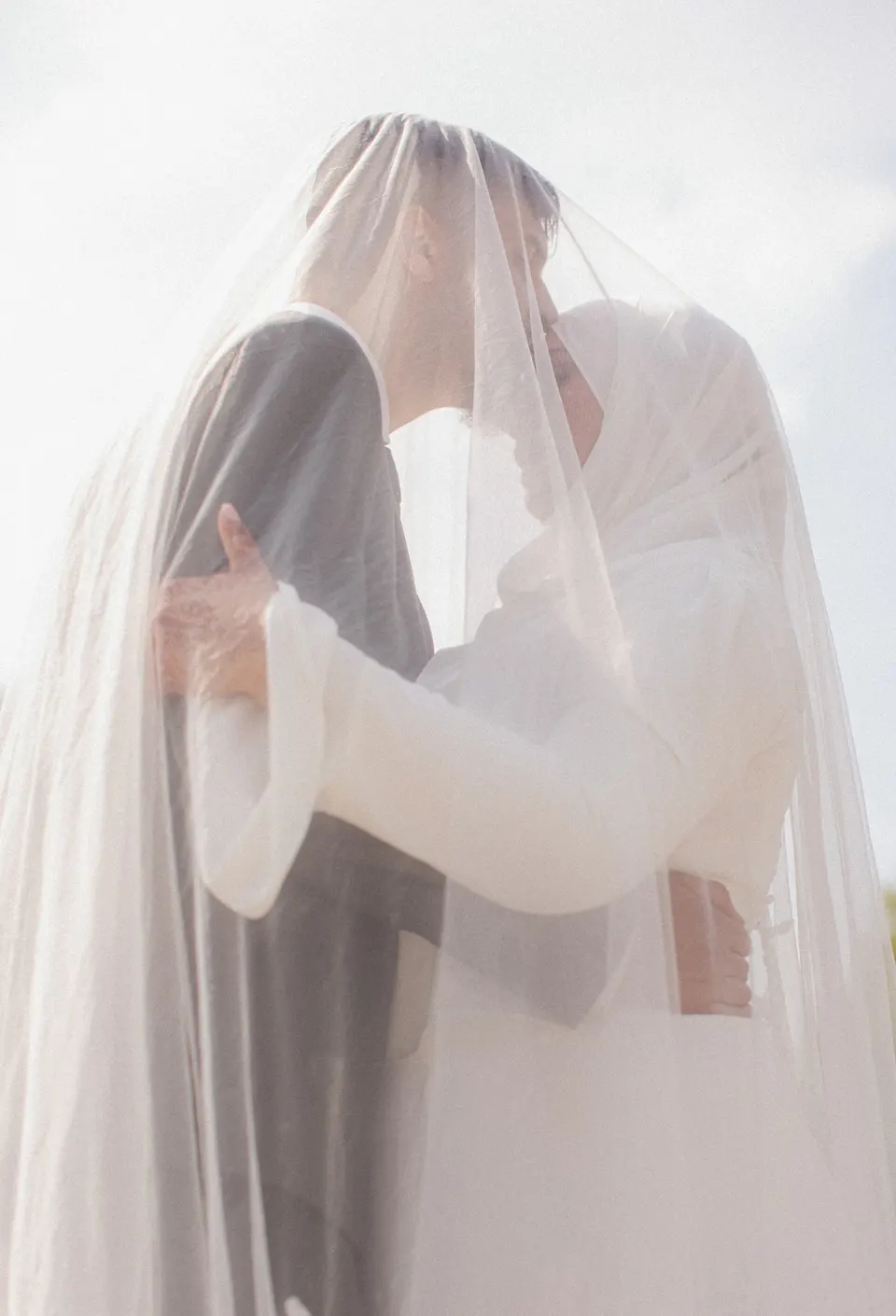 Couple qui s’embrasse sous un voile, séance photo de couple à Bruxelles par Women in Black Photography